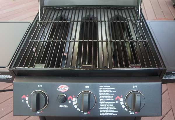gas grill with lid open showing the cooking grate