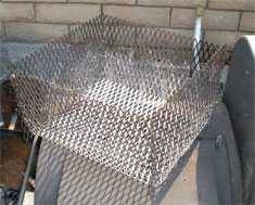 a charcoal basket slowly lights the coals