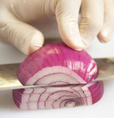 slicing the onion horizontally to cut height wise slices