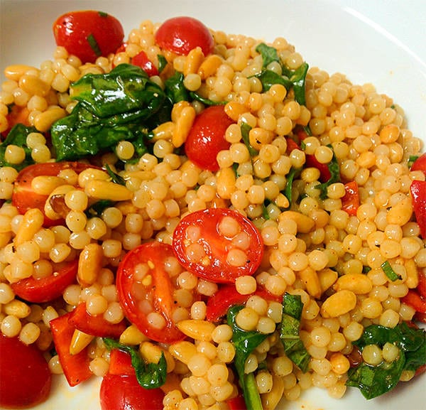 Tomatoes and spinach in a couscous salad