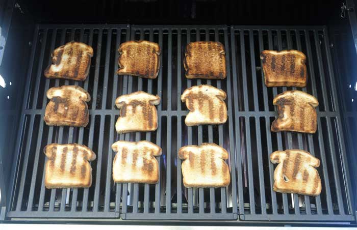 Toasted bread spread across a grill grate.
