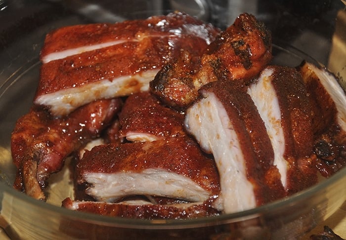 Barbecued ribs cut up in a bowl.