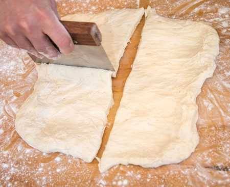 cutting pizza dough