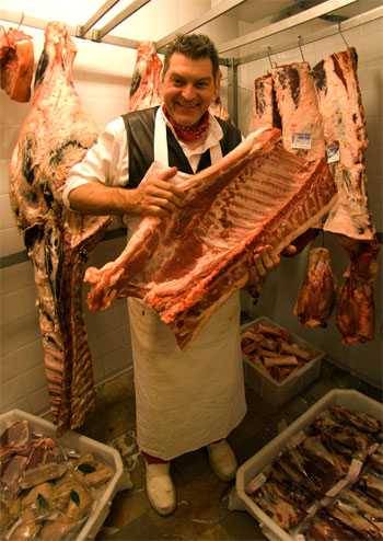 Dario Cecchini showing off a rib section for porchetta