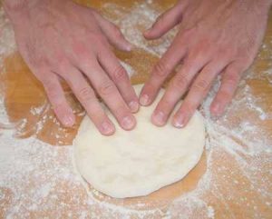 shaping pizza dough