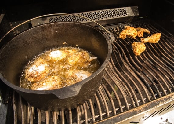 Fish Frying Outdoors In A Cast Iron Pan On Grill Stock Photo