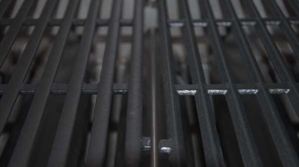 Two black, metal grill surfaces side by side.