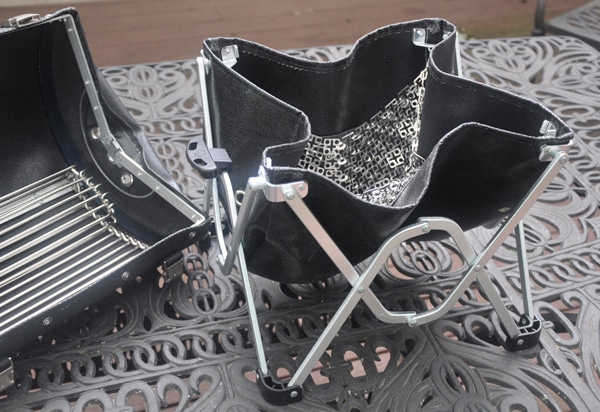 Black leathery basket attached to a shiny fold-out stand.