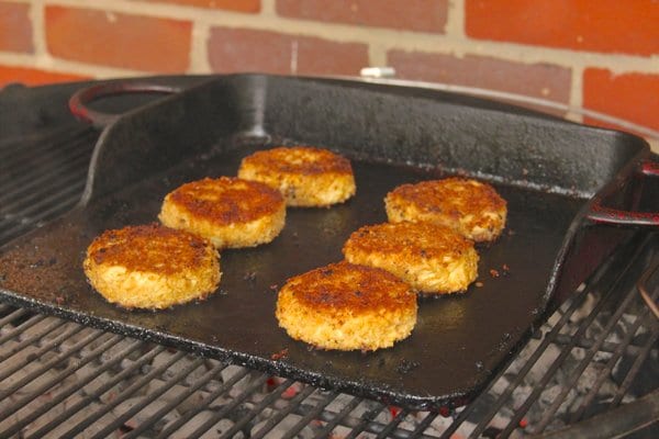 Crab cakes cooking on a griddle