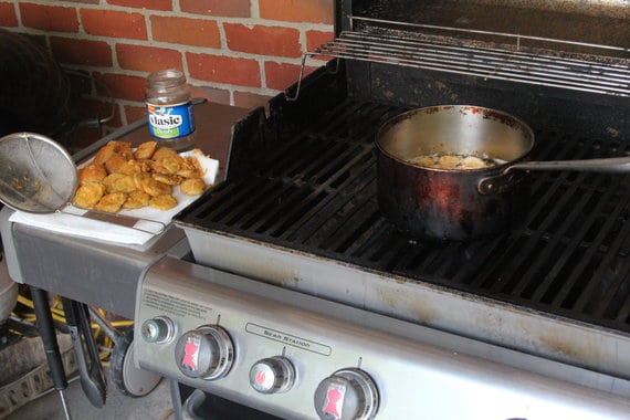Pot on a grill for deep frying pickle slices
