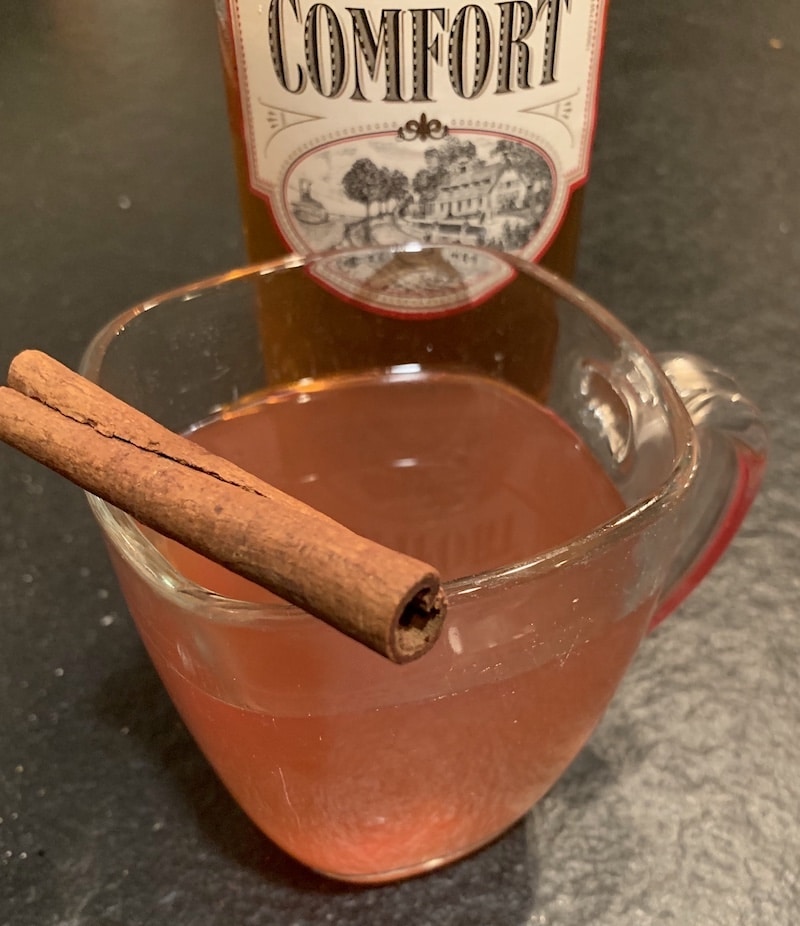 Hot Southern Comfort cider in glass with cinnamon stick
