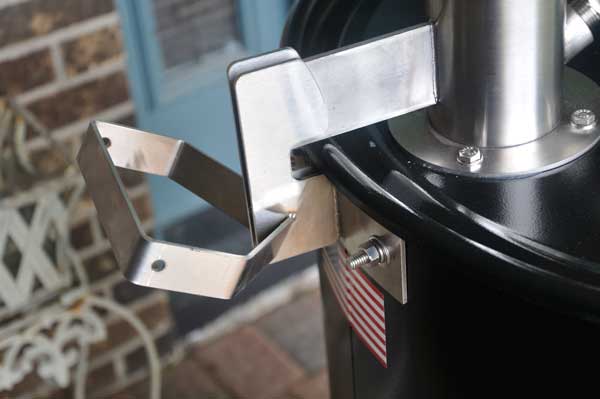 A shiny metal object attached to a black barrel