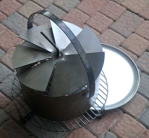 A round metal object with a spiral top on a brick walkway