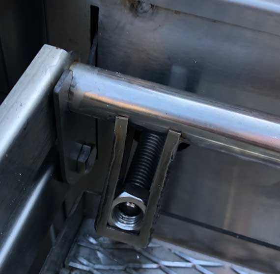 A large steel bolt going through a steel frame.