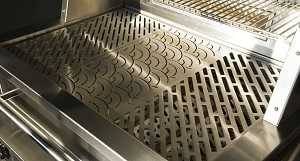 Shiny stainless steel gas grill from above with lid up showing the flat cooking surface with three different pattern cut into the steel.