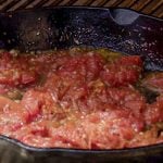 Heating tomato sauce in a skillet