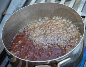 Heating the maple glaze in a pot