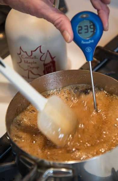 Boiling maple syrup in a pot with a thermometer