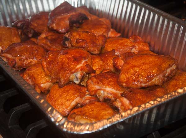 Tray of golden brown, cooked chicken parts.