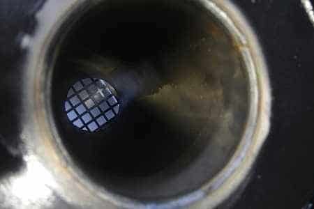 A round steel tube with a crisscrossed grate at the bottom.