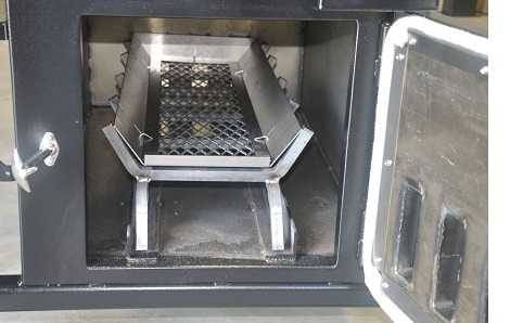 A black metal enclosure with open door showing a wood log grate inside.