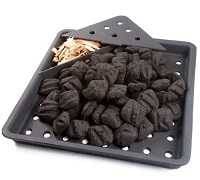 Gray metal tray filled with charcoal. The upper left corner has a small pile of wood chips.