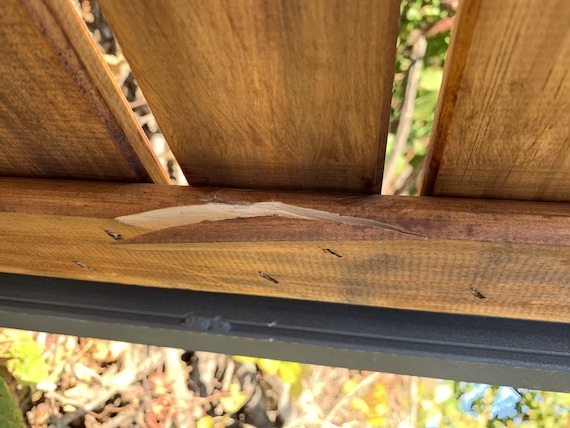 broken wood on underside of grill cart