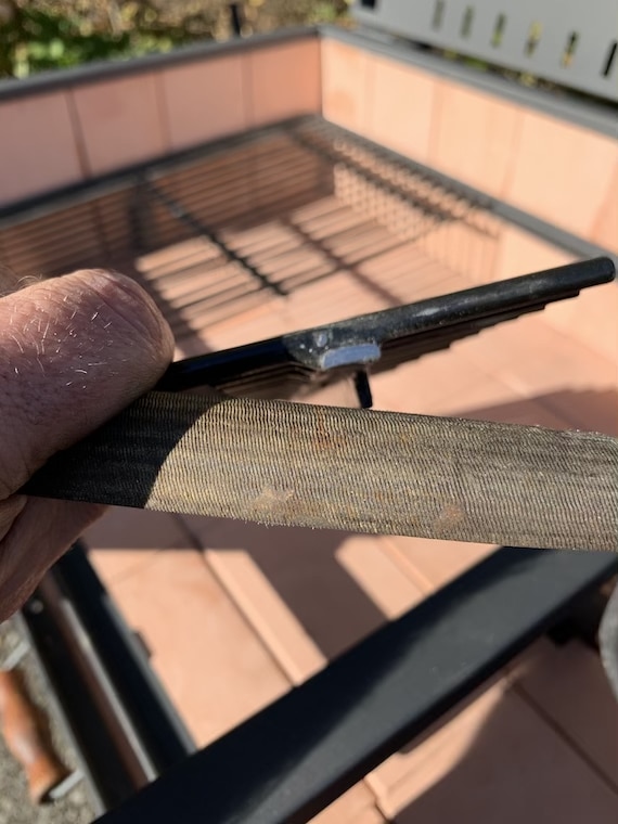 filing down a grill grate