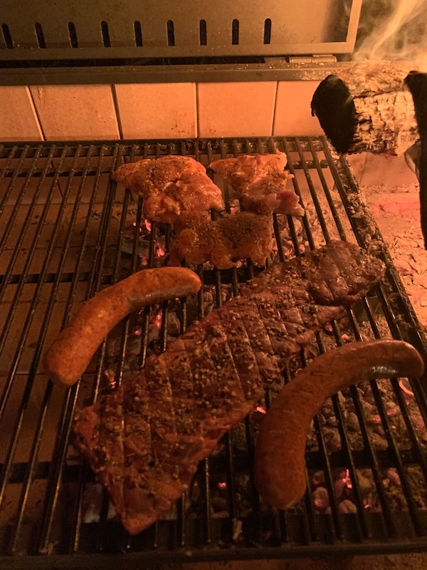 skirt steak sausages and chicken on grill
