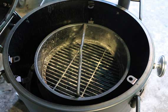 round charcoal basket inside a round barrel.