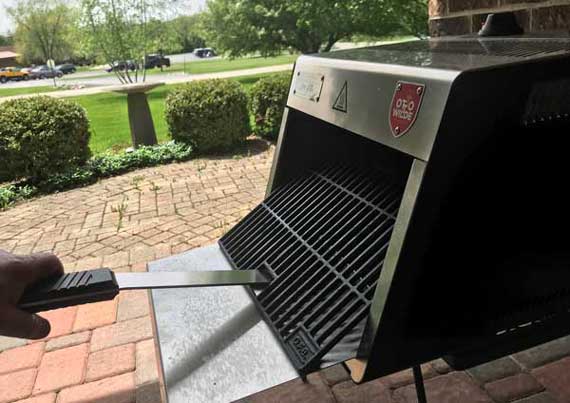 Shiny steel box. A cooking grate is flopping forward.