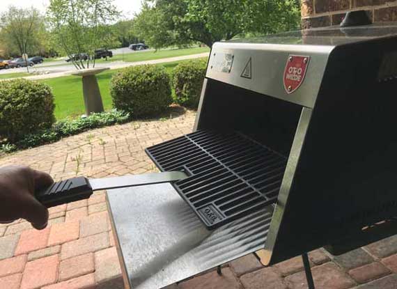 Shiny steel box. A cooking grate is sticking out.