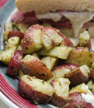red potatoes with pesto in a bowl