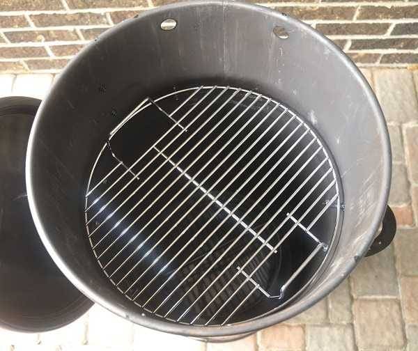 Barrel smoker from above, lid off looking at cooking grate.