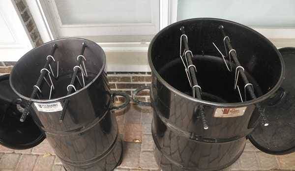 two barrel smokers from above with lids off. One smoker is small one is large