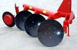 Heavy red metal frame with large black discs attached. It looks something like a plow.