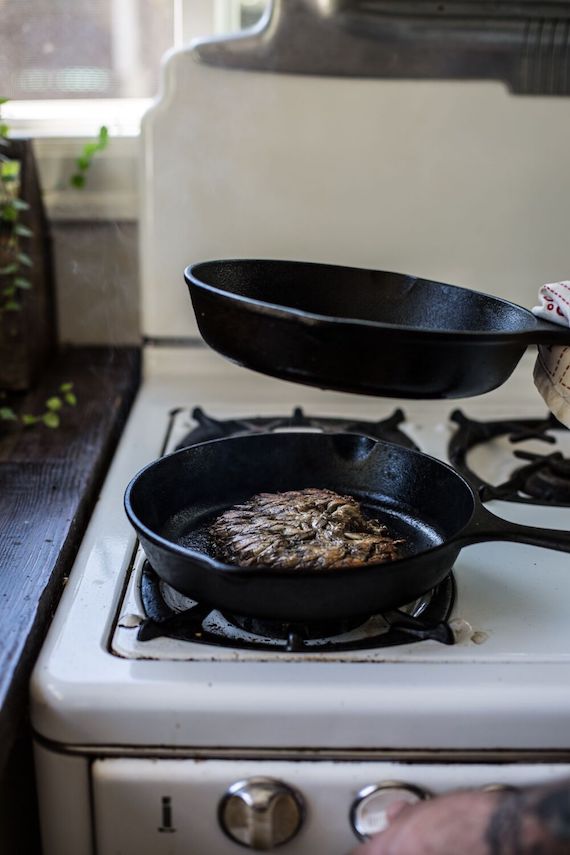 pressed and seared maitake mushroom in cast iron pan