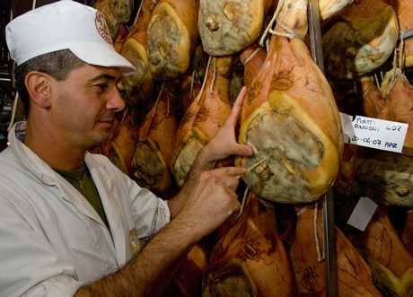 worker testing prosciutto