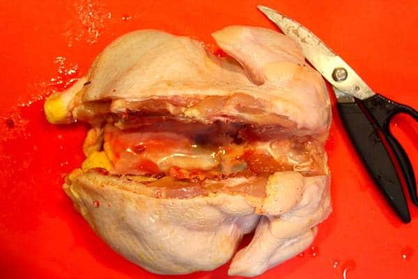 Removing the backbone from a chicken