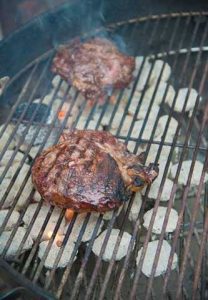 Steaks searing over direct heat