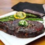 ribeye steak with butter and asparagus