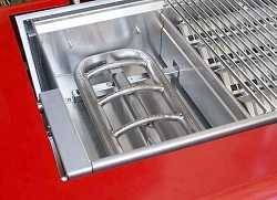 A shiny steel U-shaped gas grill burner inside a red gas grill.