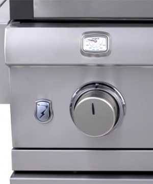 Close up of a shiny steel gas grill control knob with a thermometer positioned right above.