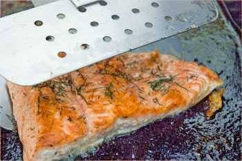 Salmon being flipped with a spatula