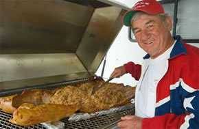 man cooking a whole hog