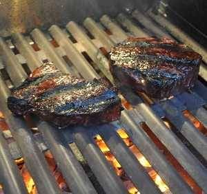 steaks seared on heavy stainless steel cooking grates