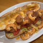 Po boy with lid off showing shrimp and andouille