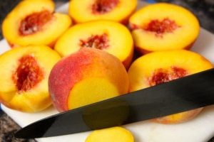 Slicing the ends off of cut peaches