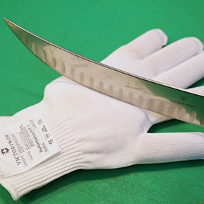image of a knife slicing a glove