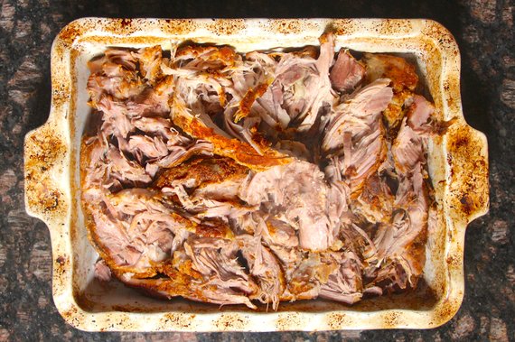 Shredded slow cooker pork butt in serving dish